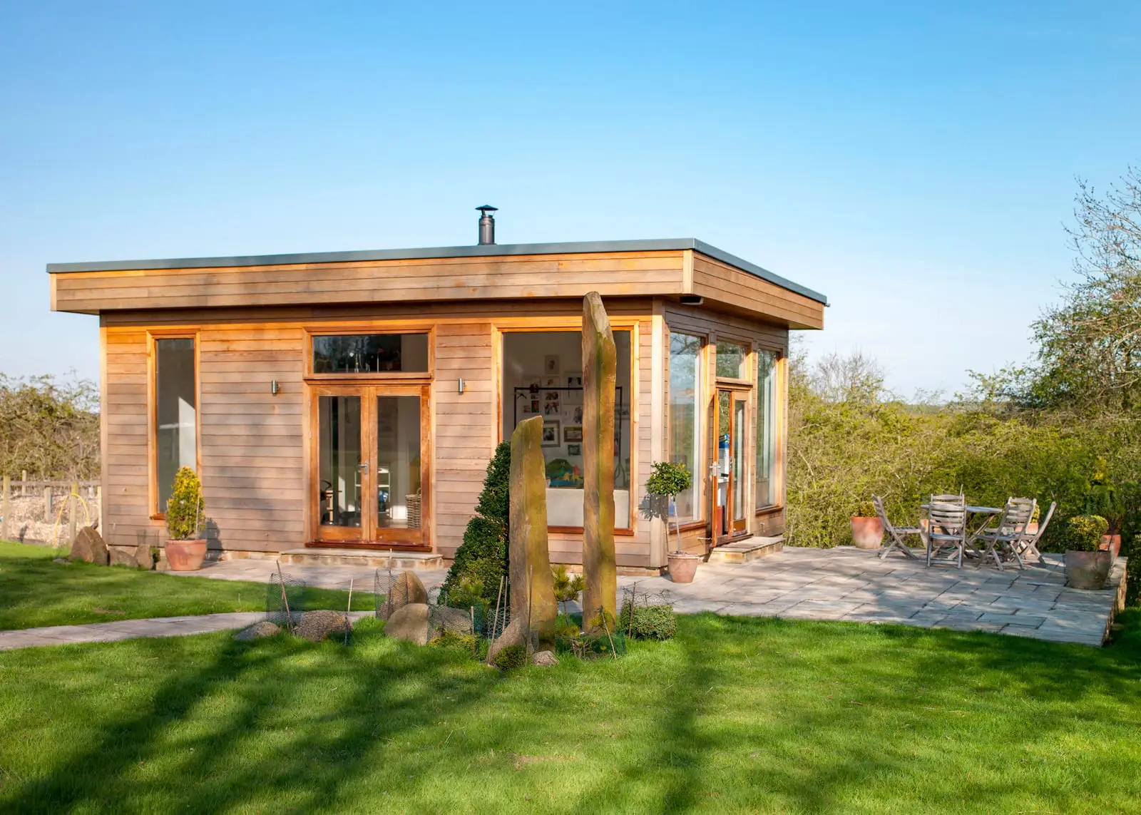 Garden room with glazed doors at the end of a garden