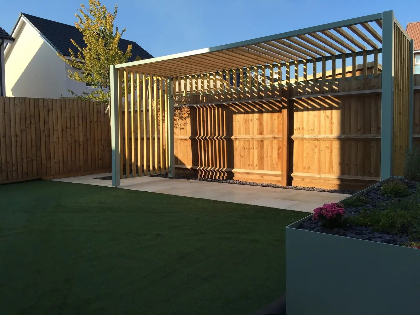 Timber pergola over a garden seating area