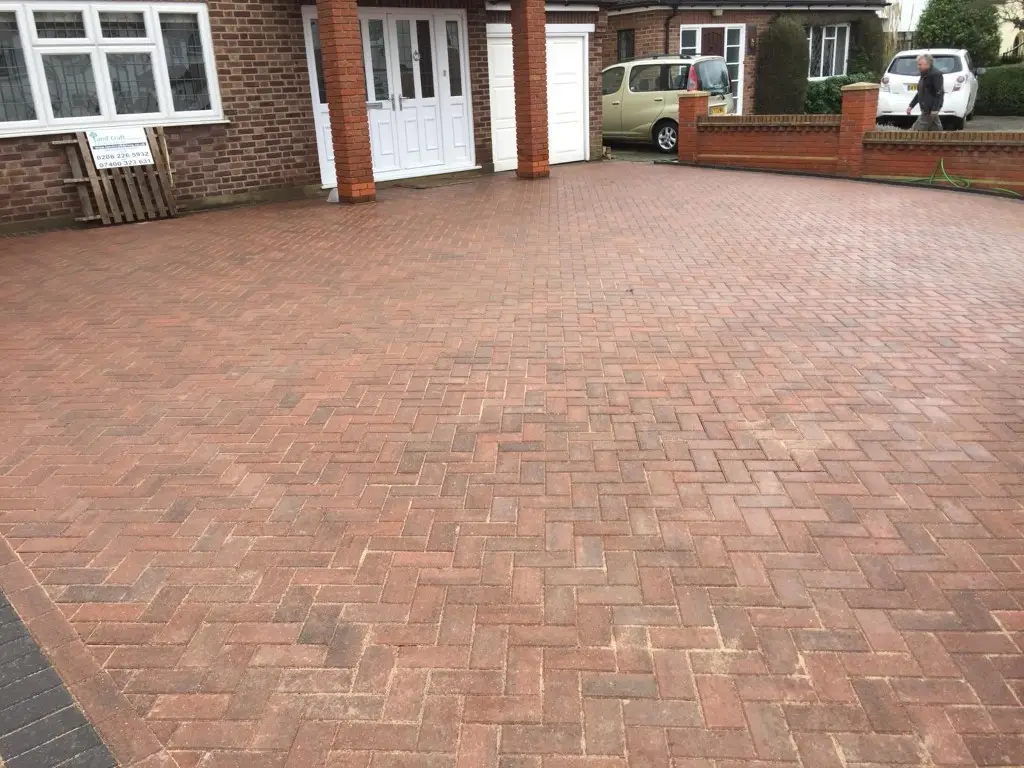 Red herringbone block paving across a wide frontage