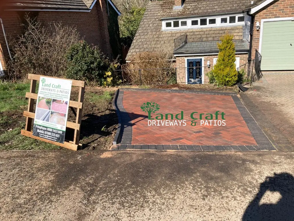 Red block paving with a charcoal border in a front garden