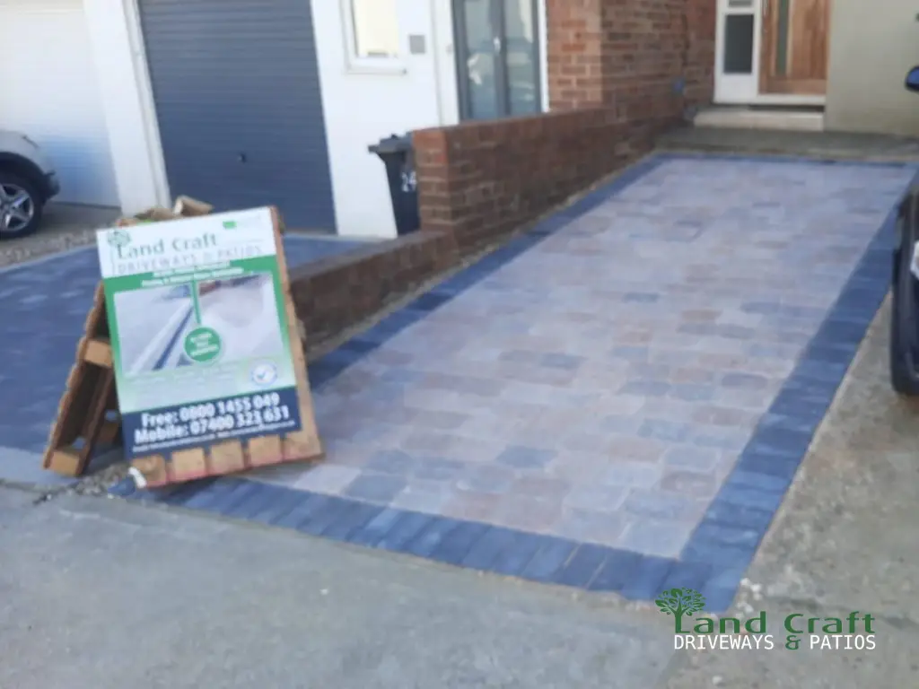 Grey block paving driveway with a blue-grey border