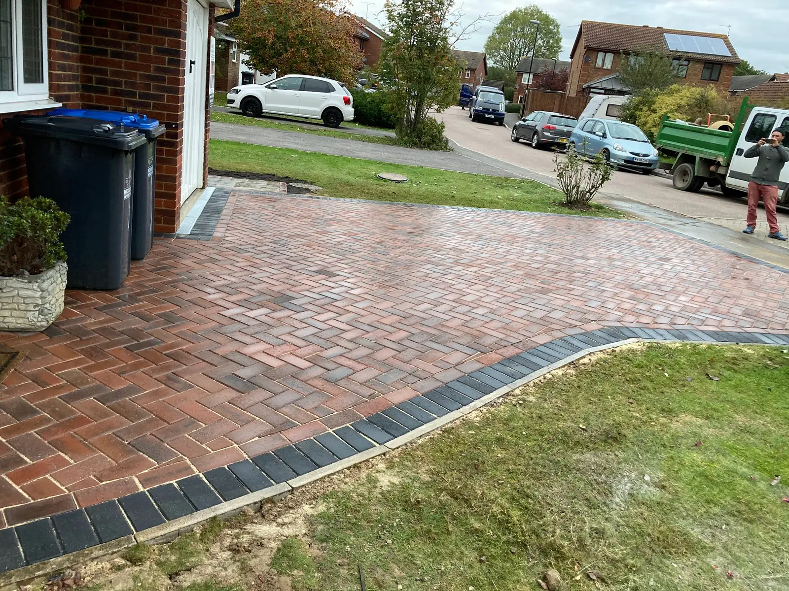 Brindle herringbone block paving curving along a lawn
