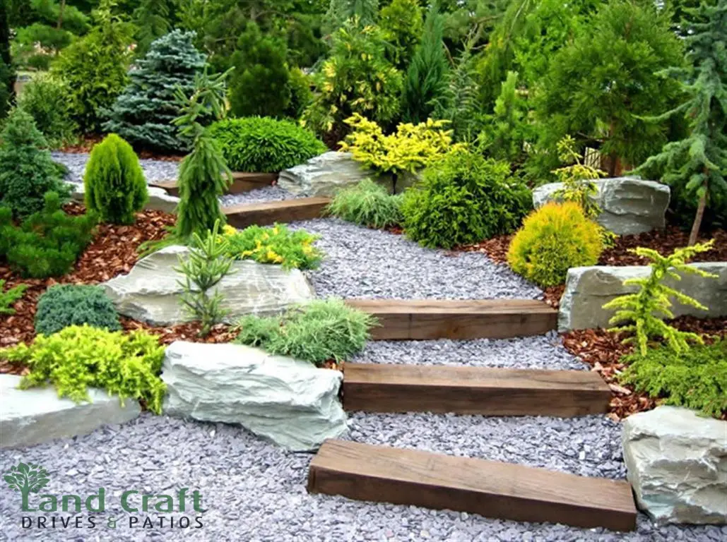 Rockery with sleeper steps, gravel and shrubs