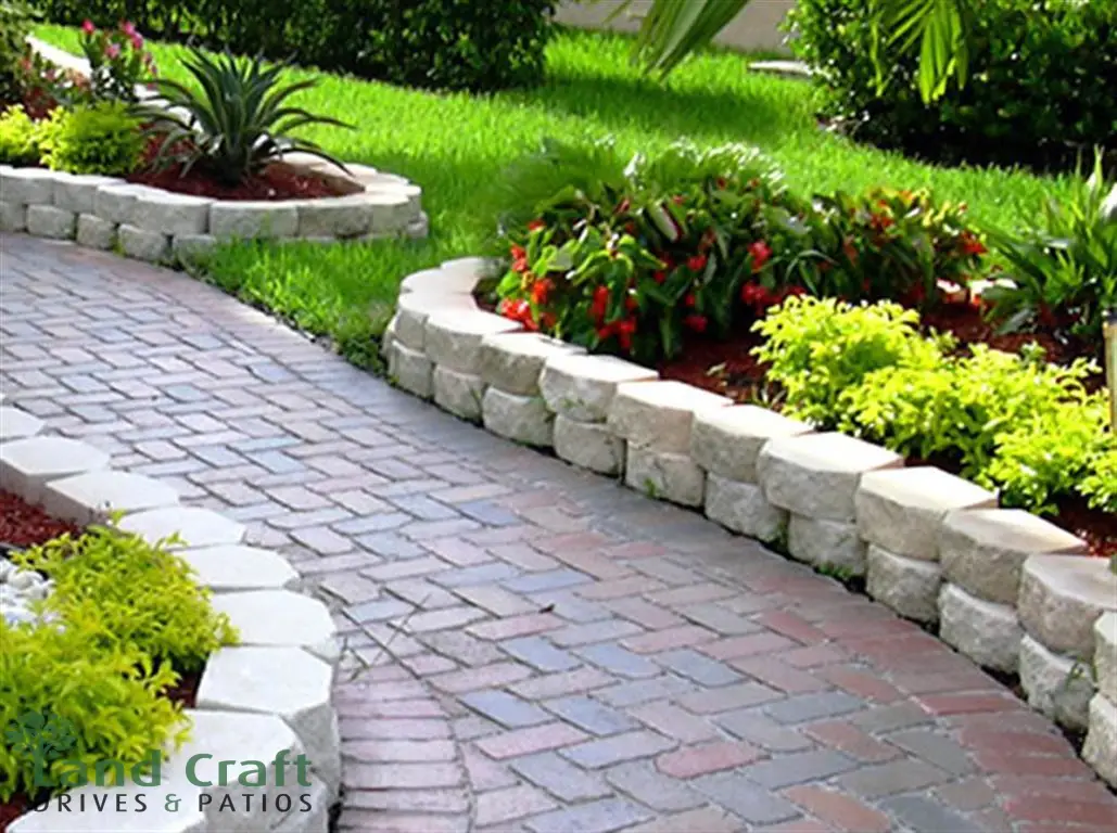 Curved block paved path with stone walling
