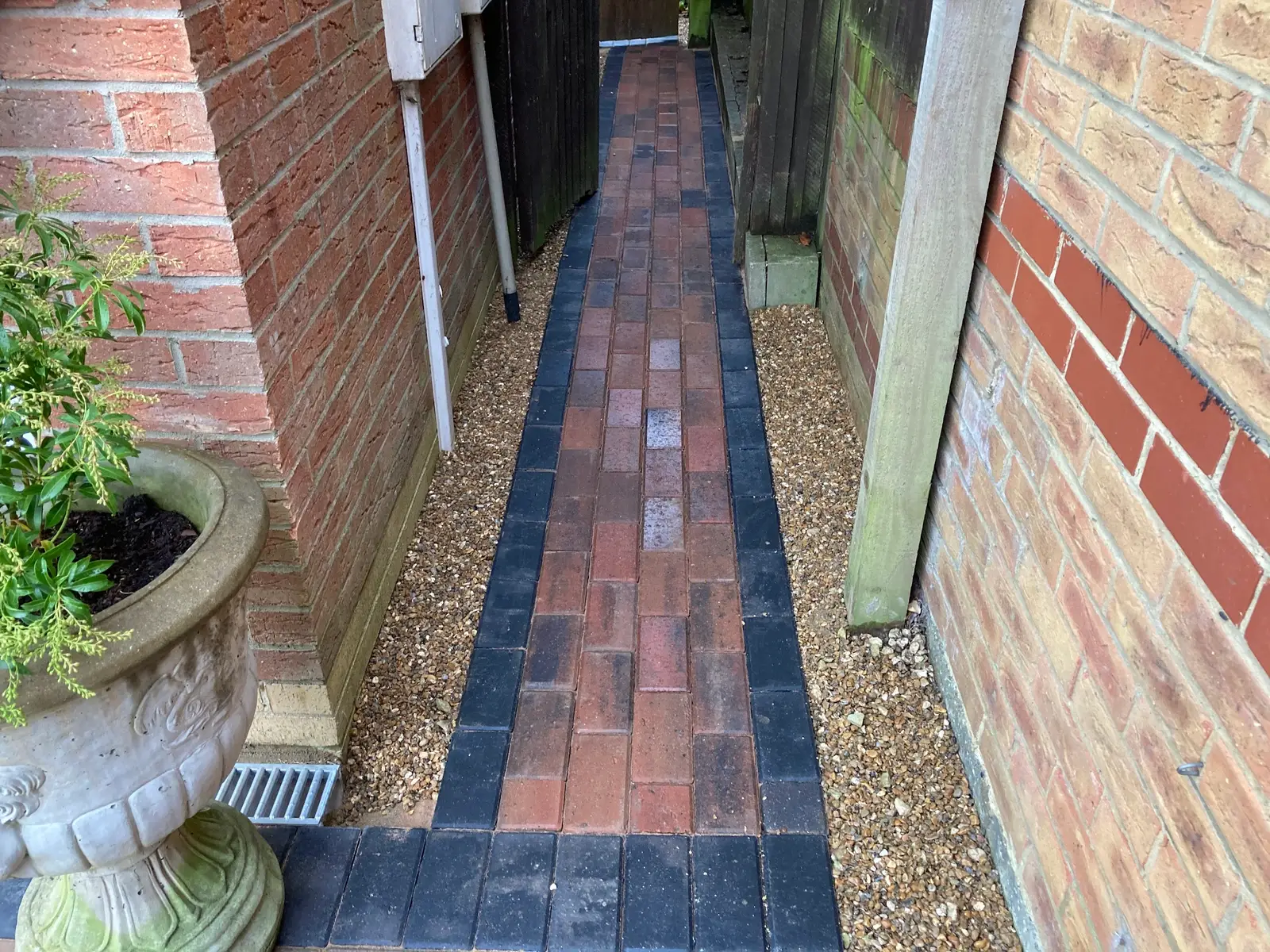 Red and charcoal block path down a side passage