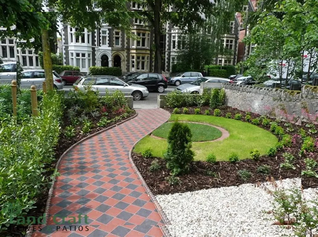 Curved red and charcoal path through a designed front garden