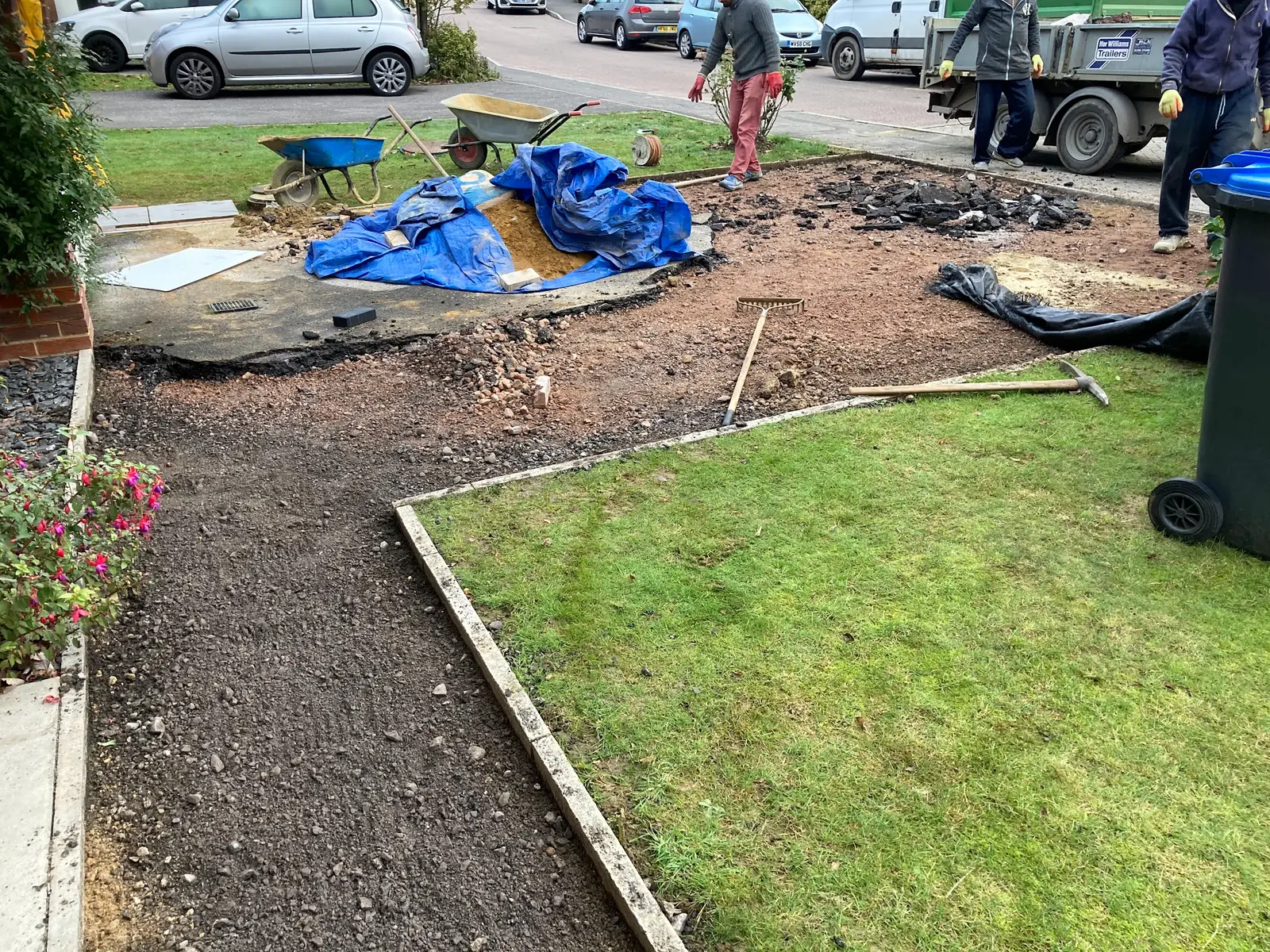 Ground prepared beside a lawn for a new path