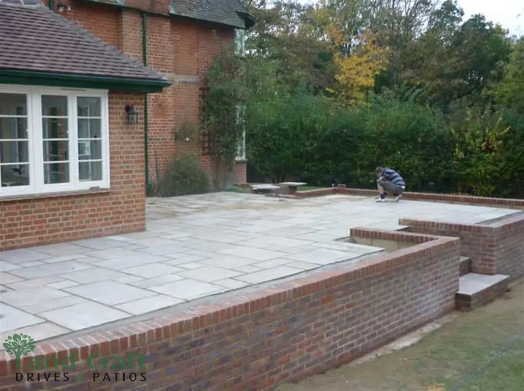 Light stone patio with brick walls and steps