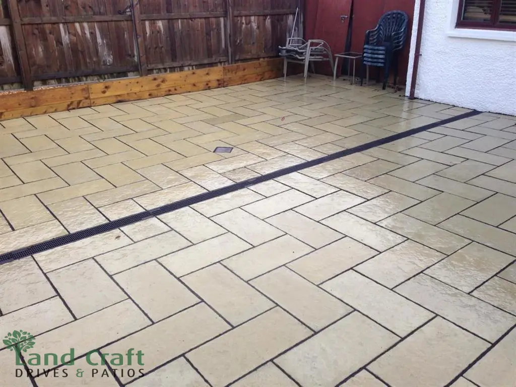 Buff porcelain paving with a dark border across a frontage