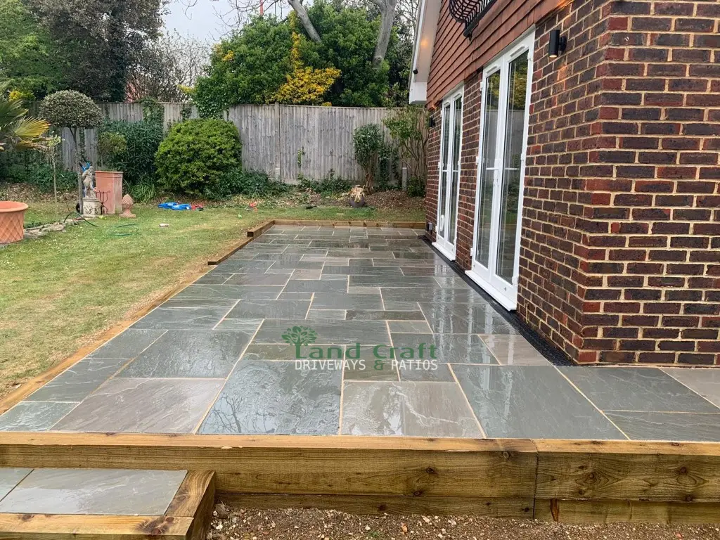 Grey porcelain patio with timber sleeper edging