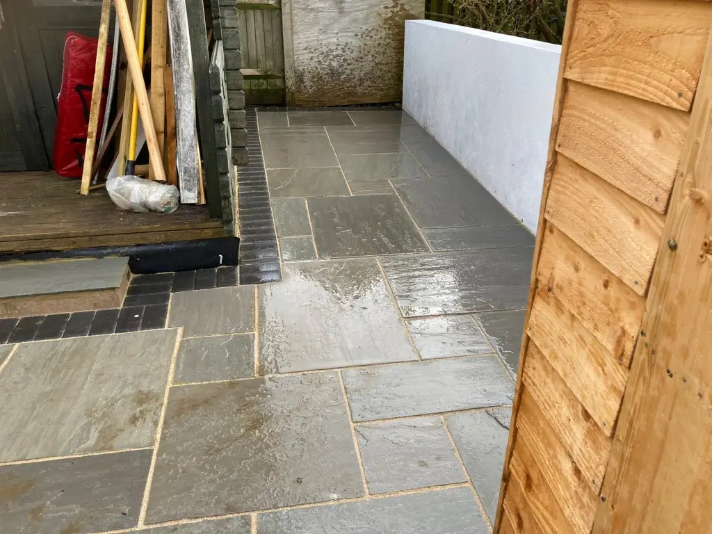 Grey natural stone patio beside a house