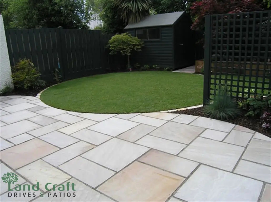 Sandstone patio around a circular lawn