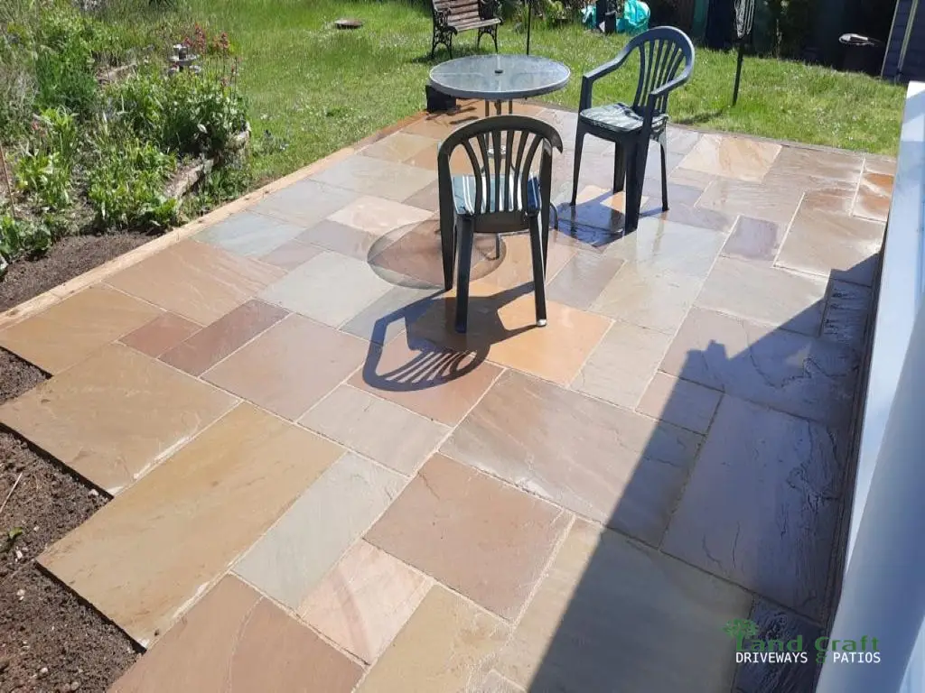 Sandstone patio with garden chairs and a table