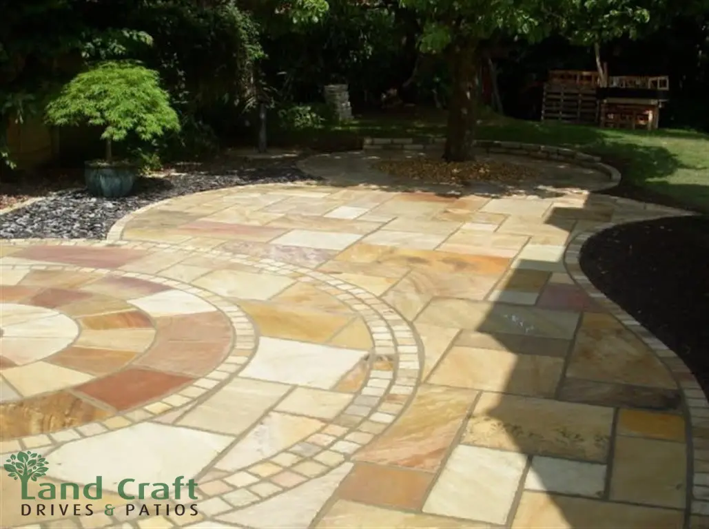 Sandstone patio with a circular feature and curved edge