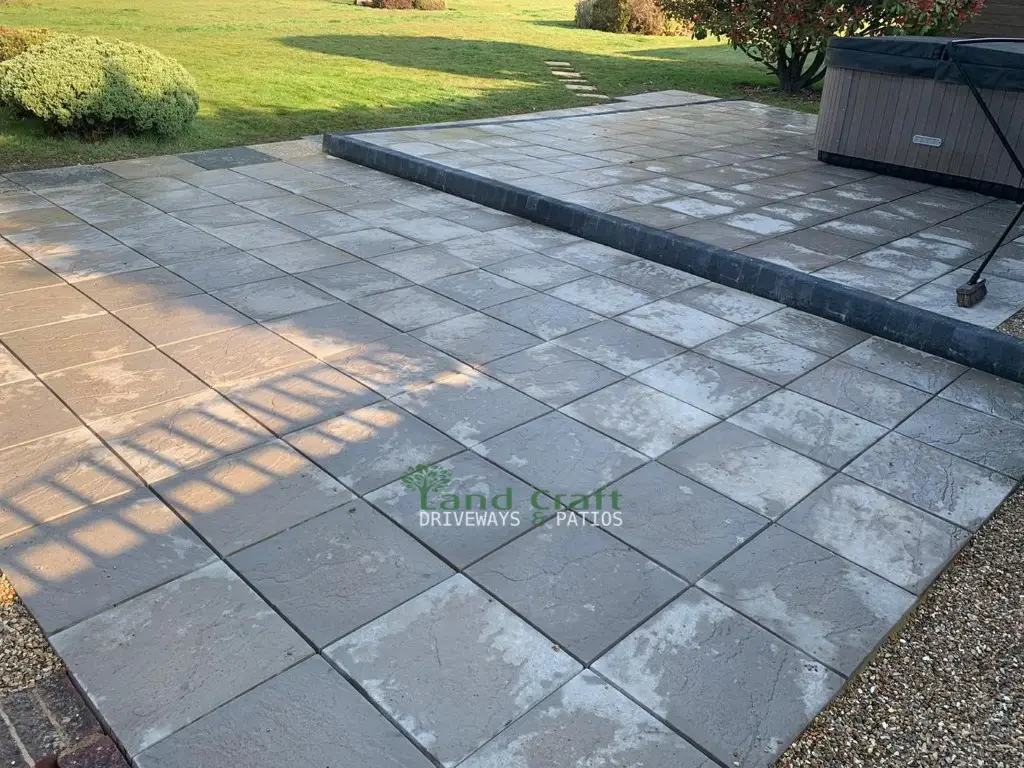 Charcoal slab patio with a step
