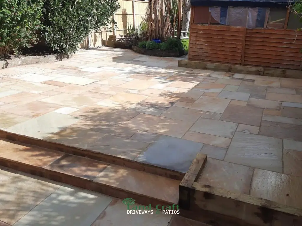 Sandstone patio with timber sleeper edging