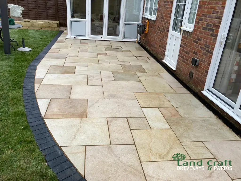 Buff porcelain patio with a curved charcoal border