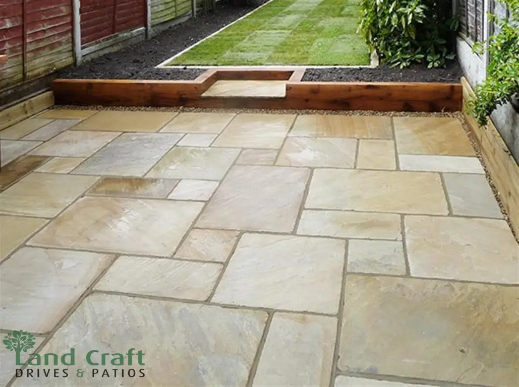 Sandstone patio with a raised sleeper bed