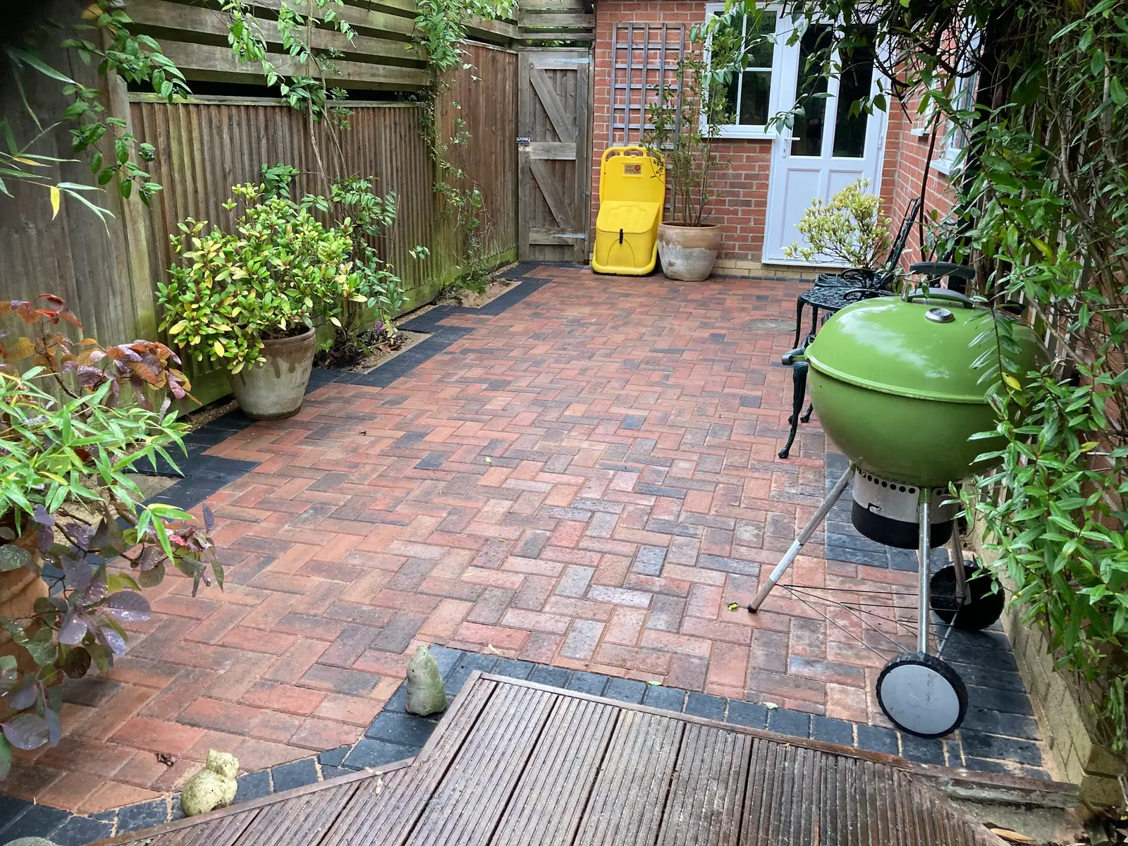 Red block paved back garden with planting